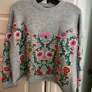 Women’s large Haute Rogue sweater. Embroidery all the way around.